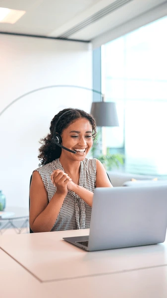 woman-wearing-headset-sitting-desk-600nw-2464352483
